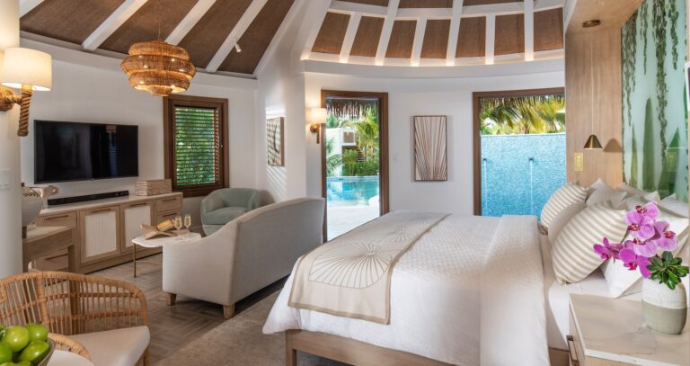 A suite bedroom and living area opening to the pool outside, Sandals Dunn's River