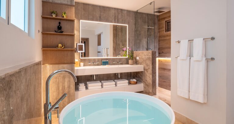 A bathroom with a round soaking tub and a walk-in shower, Sandals Dunn's River