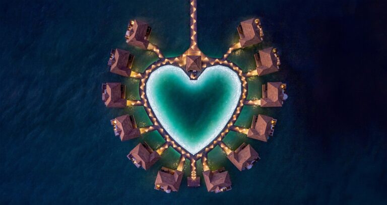 Heart-shaped lagoon surrounded by overwater bungalows, seen directly from above, Sandals Royal Caribbean Resort and Private Island