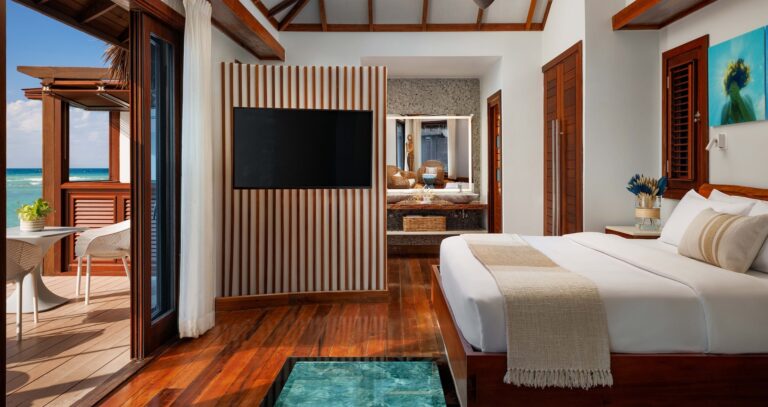 An overwater bungalow bedroom, wood deck and sea view, Sandals Royal Caribbean Resort and Private Island