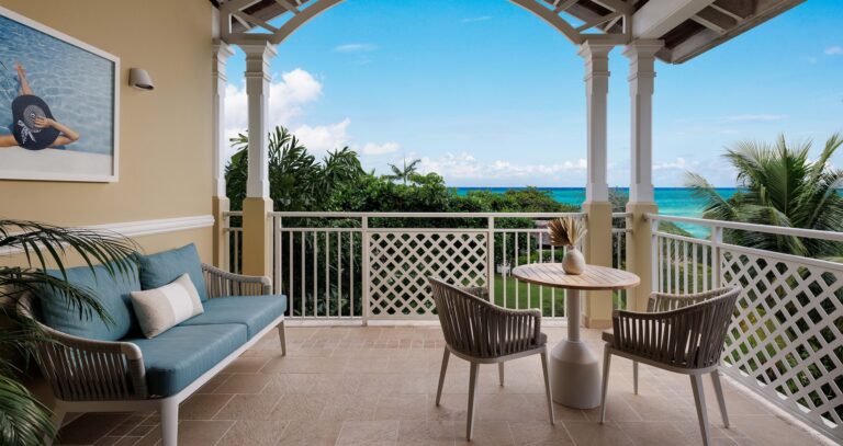 Covered balcony with seating and a view of the garden and sea, Sandals Royal Caribbean Resort and Private Island