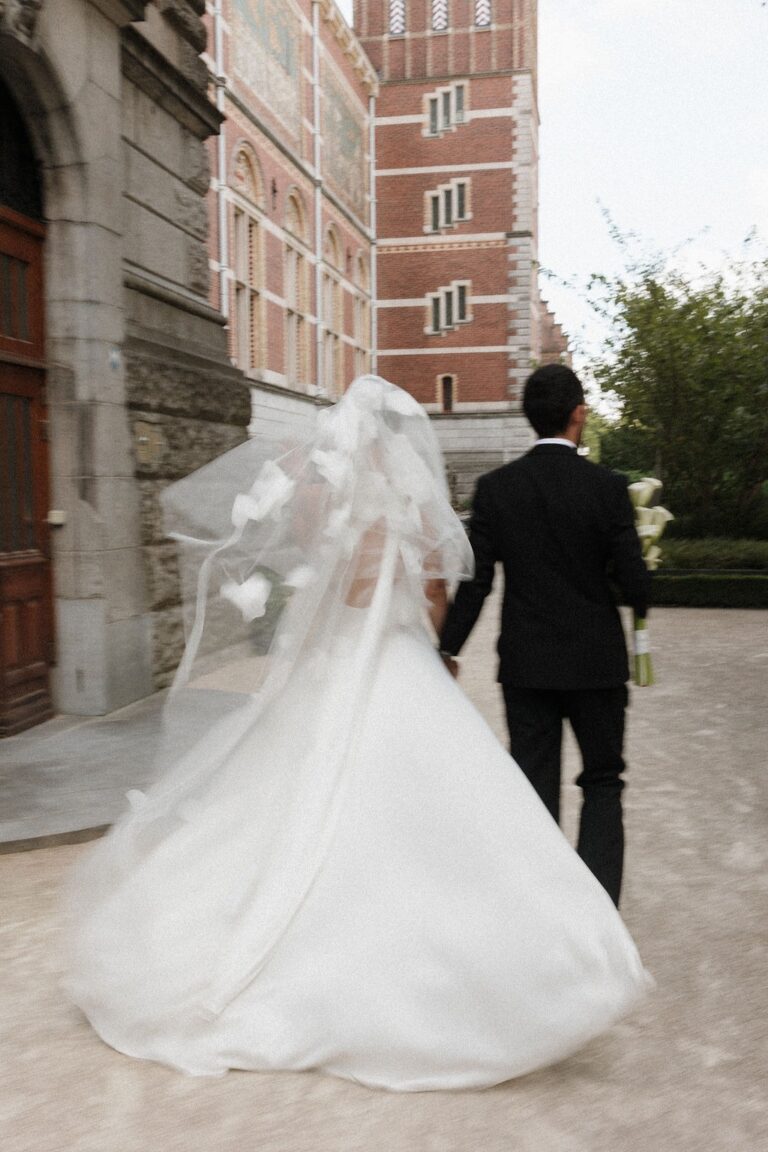 Couple walking away in a flowing veil, Amsterdam, Sante Weddings