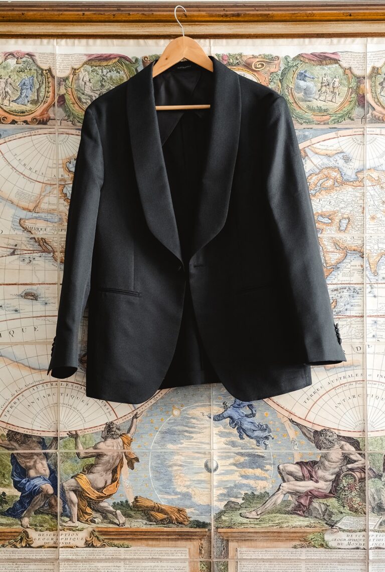 Groom's jacket hung against an antique map, Villa Medicea di Lilliano, Tuscany, Sante Weddings
