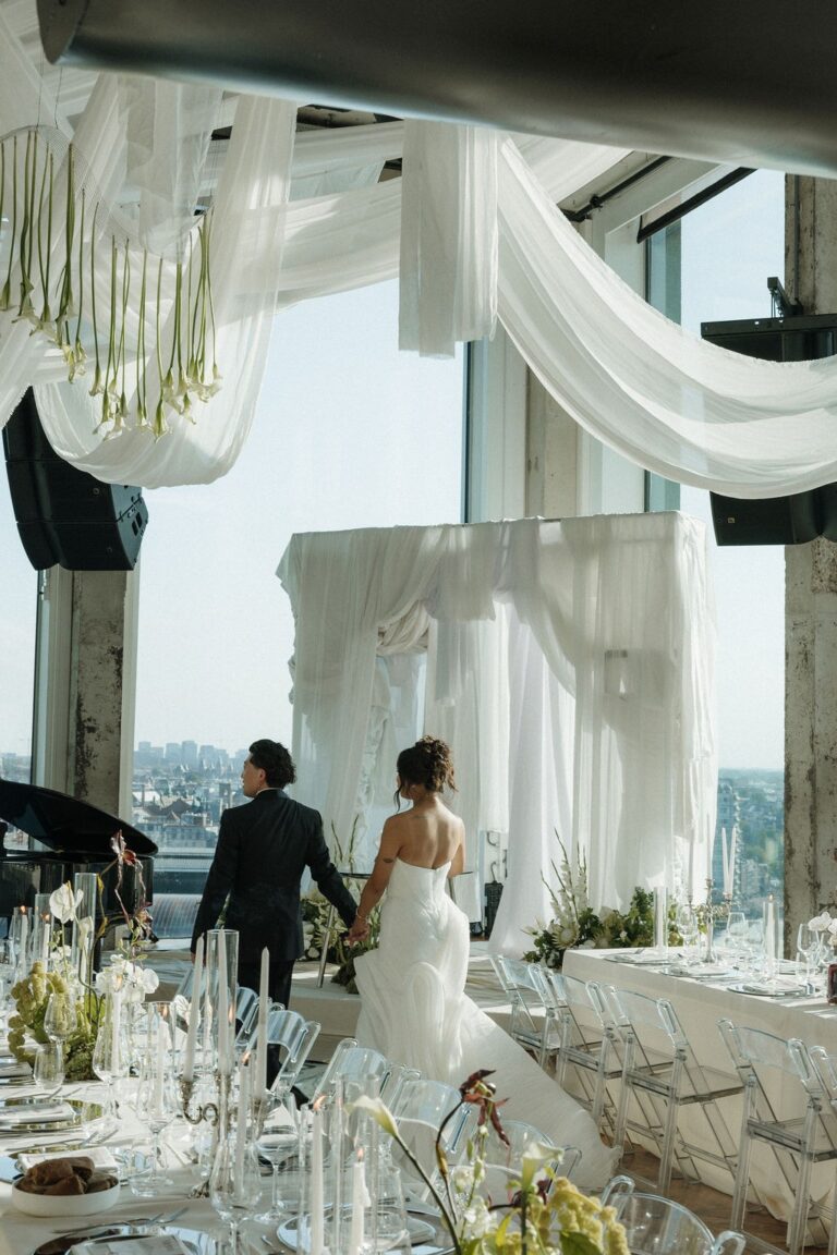 Bride and groom at a draped dining space with city views, The Loft, A'DAM Tower, Amsterdam, Sante Weddings