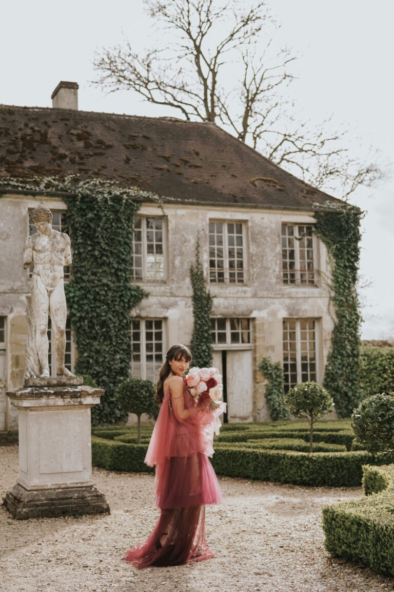 Bride with a bouquet in a walled garden at a French chateau near Paris, Sante Weddings