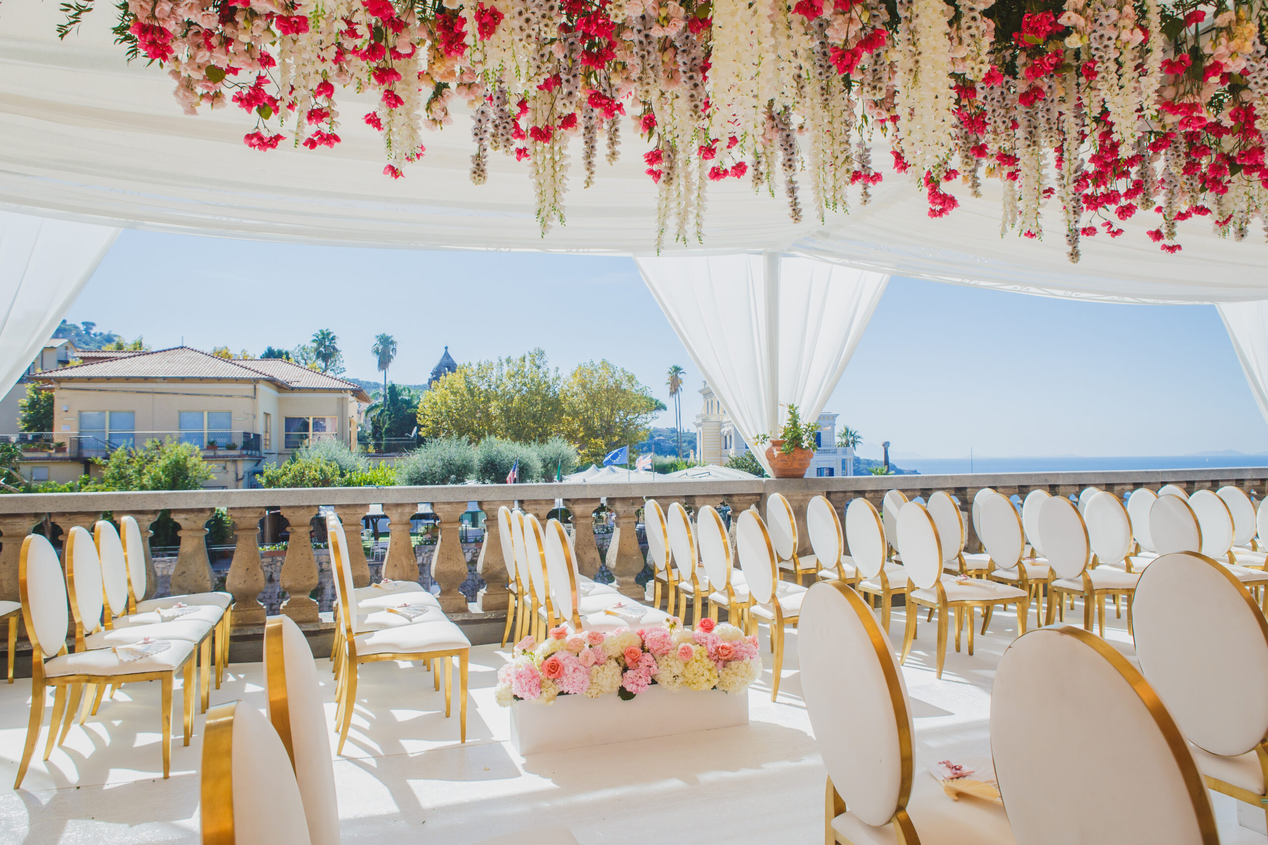 Gold chairs and a hanging flower canopy for a sea-view terrace ceremony at the Excelsior Vittoria, Sorrento, Sara D'Angelo