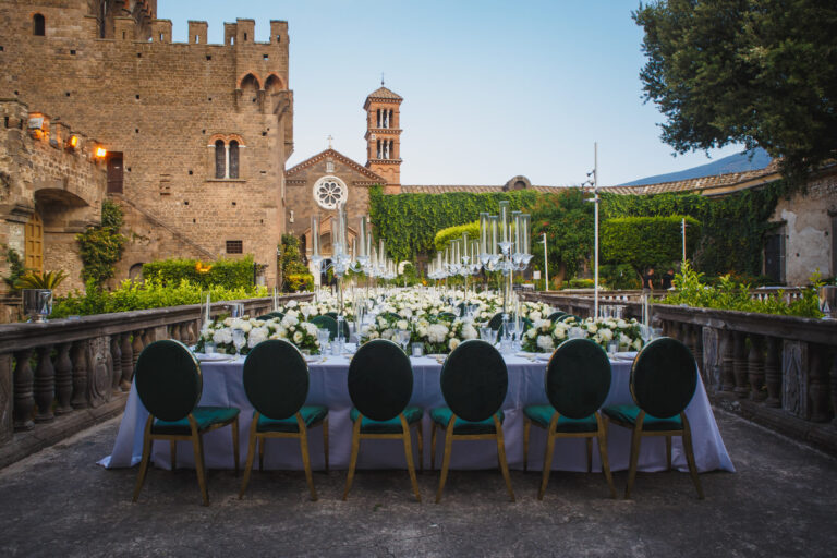 Long dinner table with green velvet chairs on a terrace of Castello Lancellotti, Lauro, Sara D'Angelo