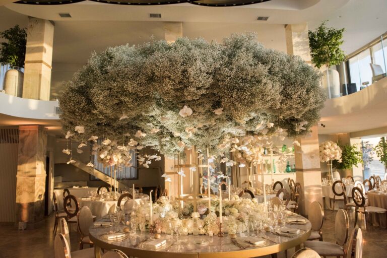 Reception room with a large olive-tree centrepiece at Punta Romana, Sara D'Angelo