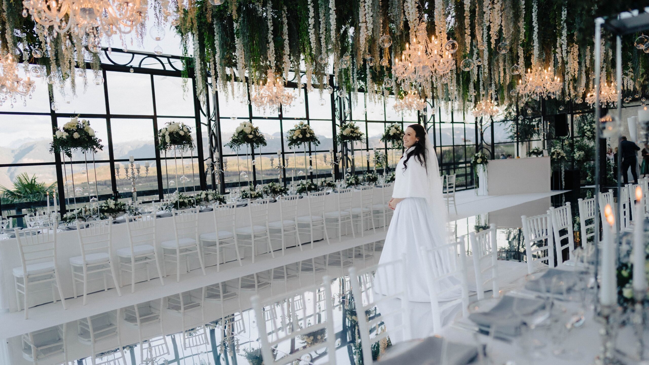 Bride at the mirrored aisle in the glasshouse ceremony space, Sarah Linow