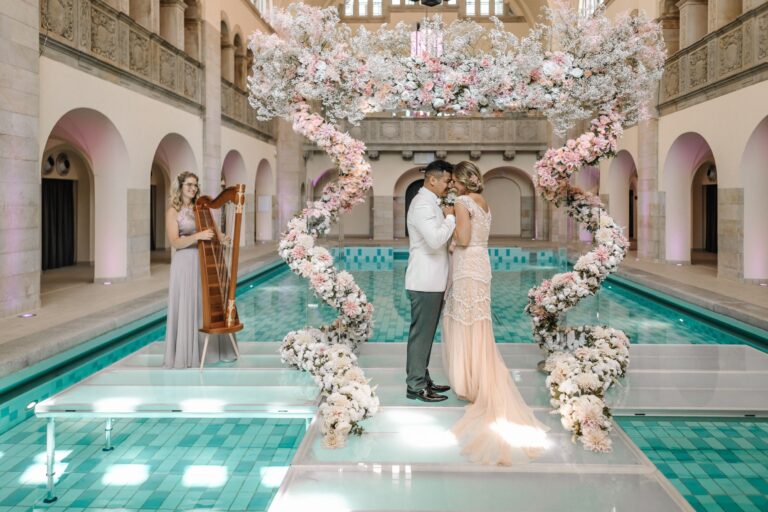 Harpist and couple on a floral stage over a tiled pool, Berlin, Sarah Linow