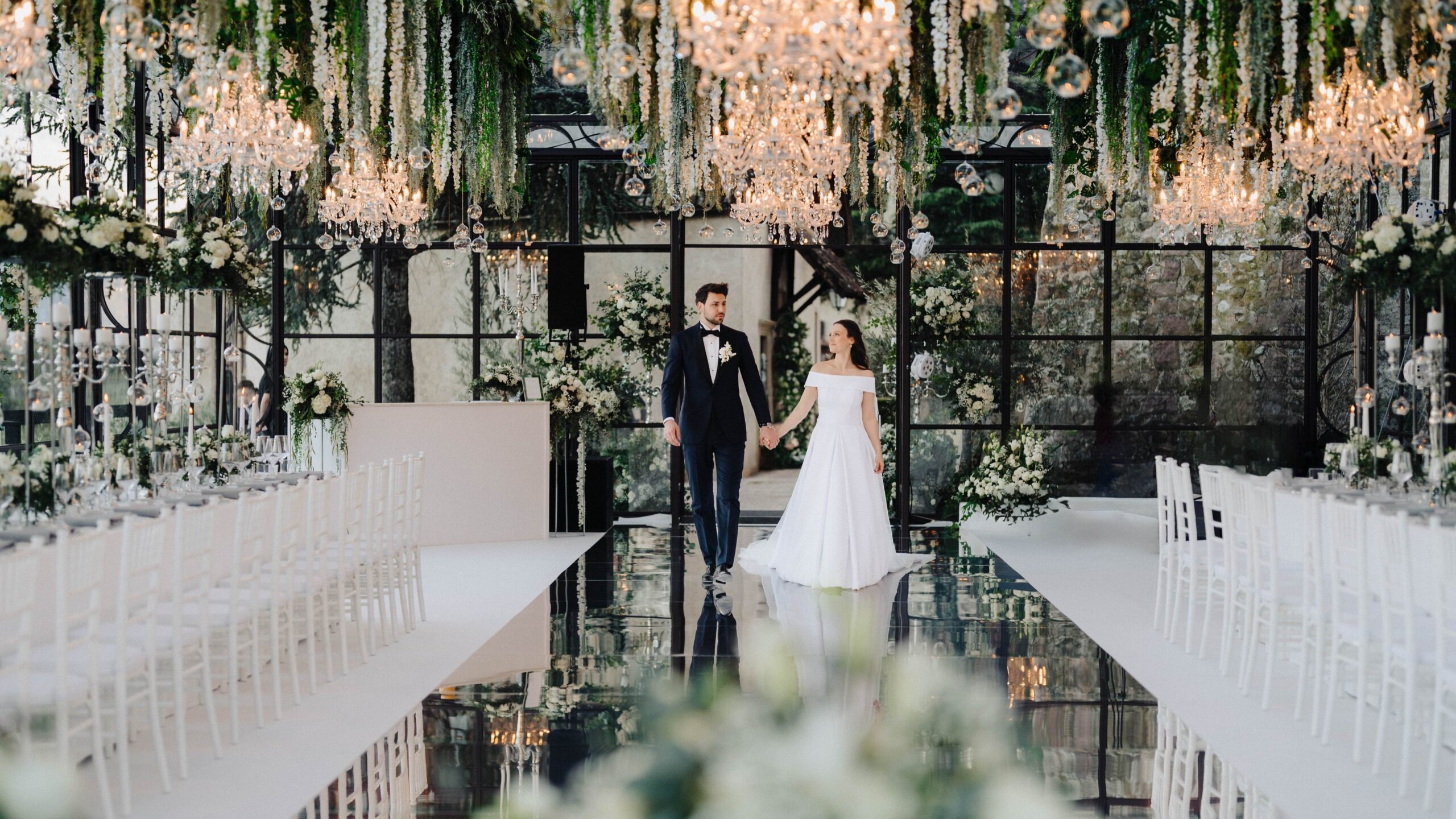 Couple walking the mirrored aisle between long tables, Sarah Linow