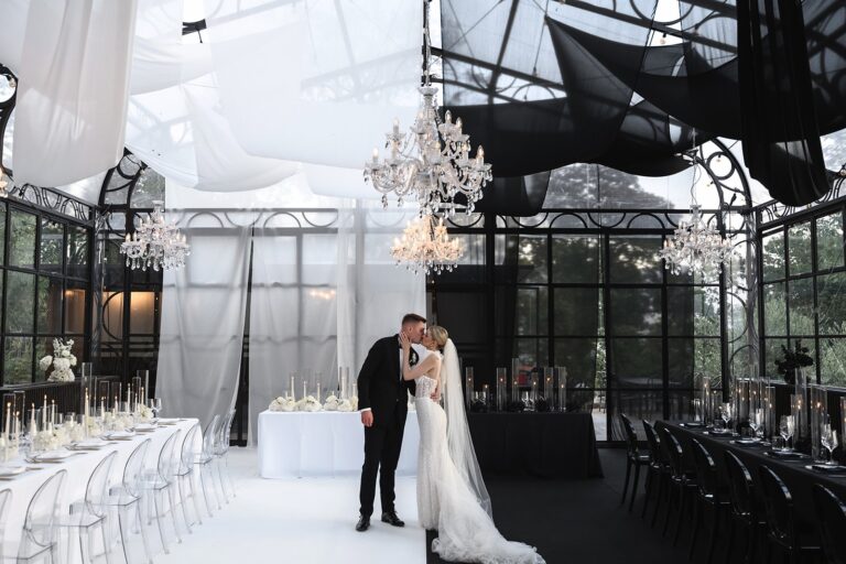 Couple kissing at the black and white styled dining room, Sarah Linow