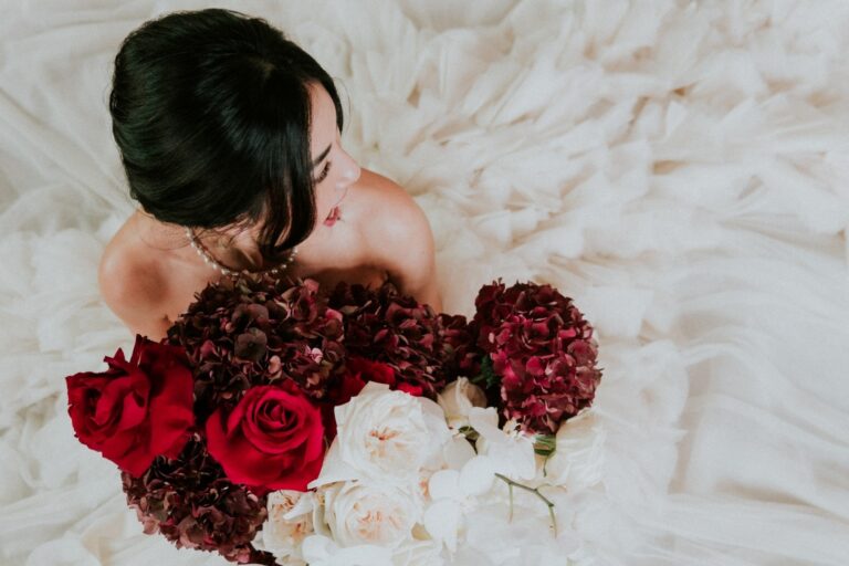 Bridal bouquet of red and cream roses over tulle, Sarah Linow