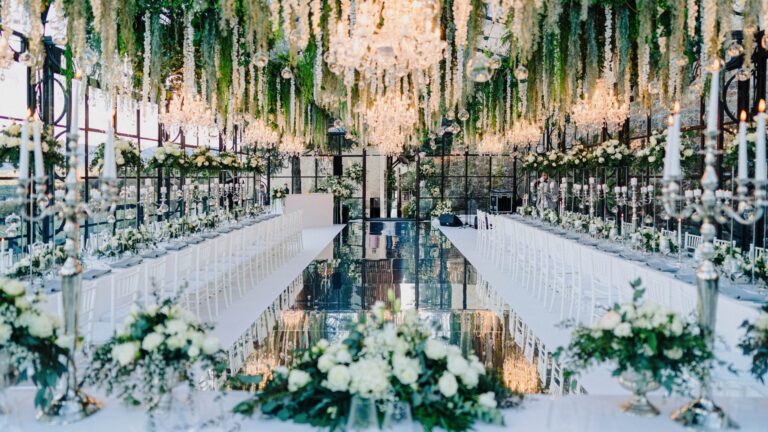 Long reception tables with greenery above a mirrored floor, Sarah Linow