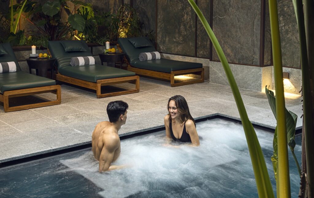 A couple in the outdoor spa pool at the wellness centre, Savoy Hotel & Spa