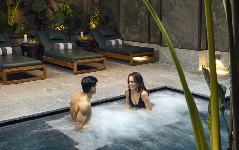 A couple in the outdoor spa pool at the wellness centre, Savoy Hotel & Spa