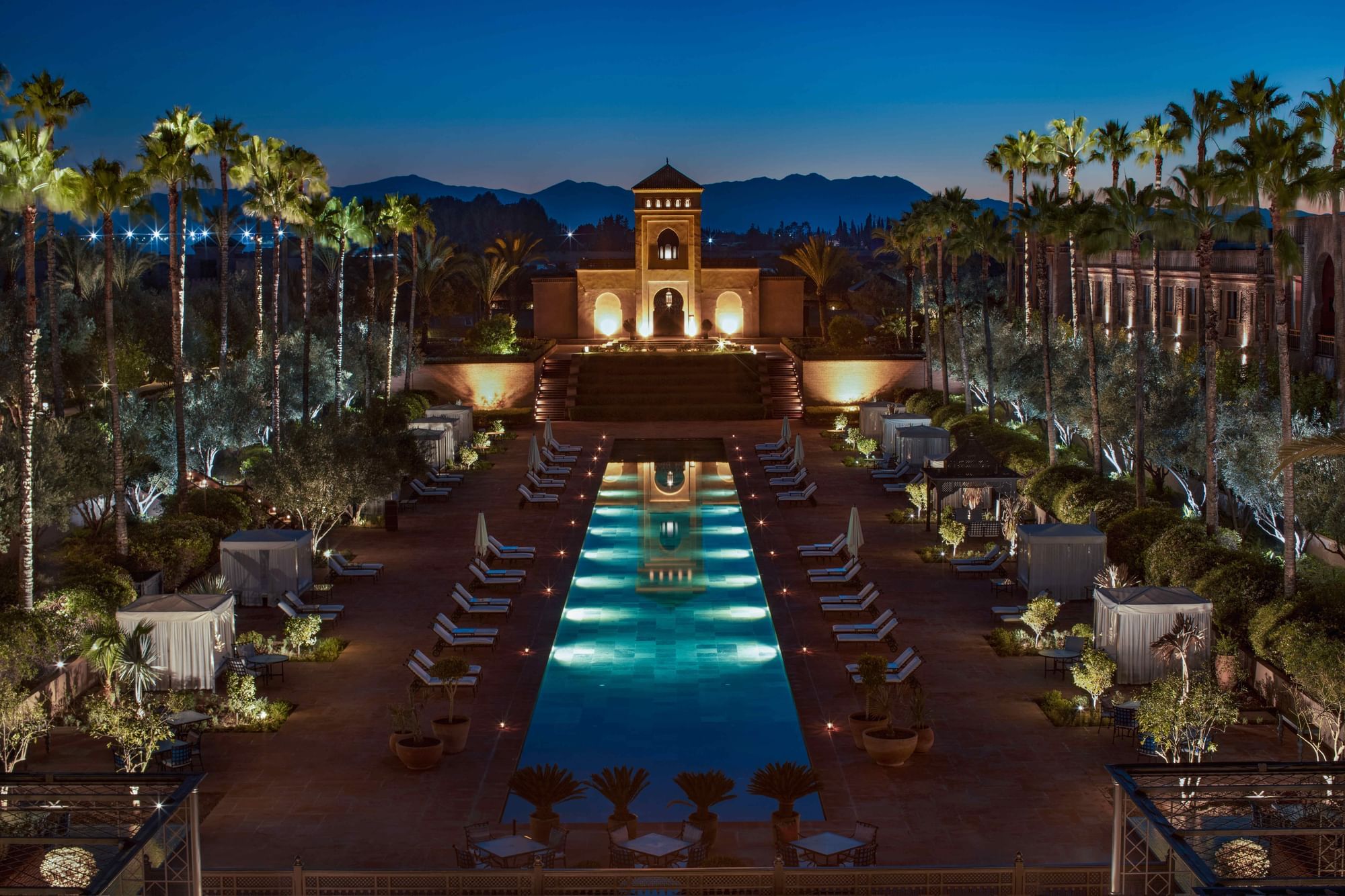 Gardens and the central pool at dusk, with the Atlas Mountains beyond, Selman Marrakech