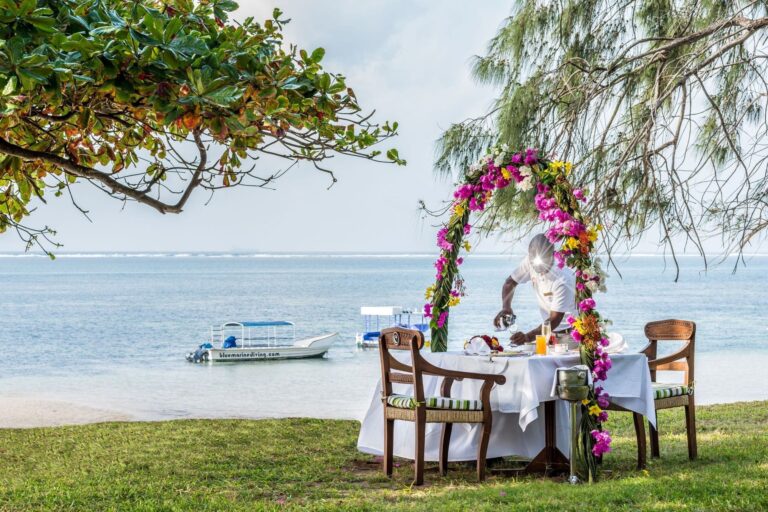 Romantic beach breakfast table beneath a floral arch by the sea, Serena Beach Resort & Spa