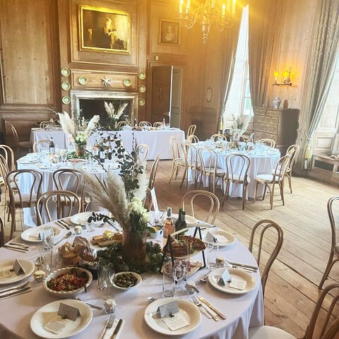 Round tables dressed with pampas grass in a panelled hall, Serendipity Street