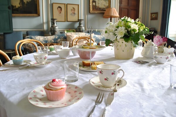 Tea table in a panelled room with cupcakes and fresh flowers, Serendipity Street