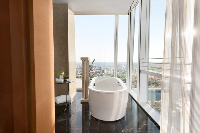 The freestanding bath in the Iconic Shard Suite, set against the glass, Shangri-La Hotel, The Shard, London