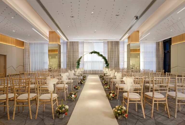 A ceremony aisle with a floral arch in One Space, Sheraton Grand Hotel & Spa, Edinburgh
