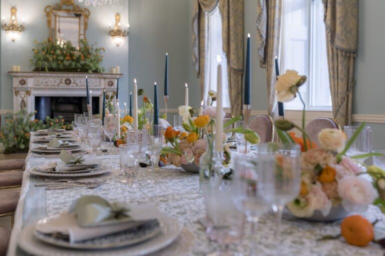 Ranunculus and tulip centrepieces dress a table beneath a floral mantel garland, Shilpa Reddy