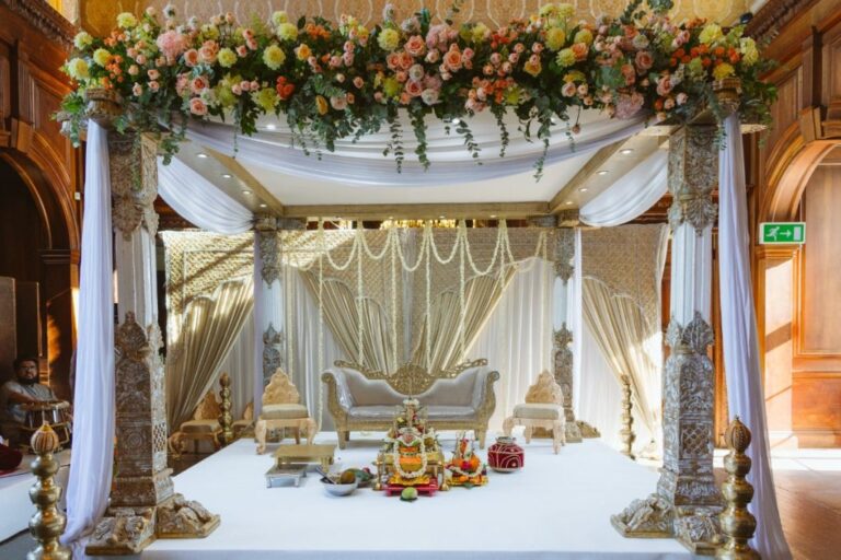 A full floral mandap, its carved pillars framed in rose, dahlia and marigold, Shilpa Reddy