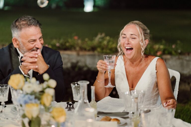 A toast at the dinner table, yellow roses on the cloth, Sicilian Wedding Day