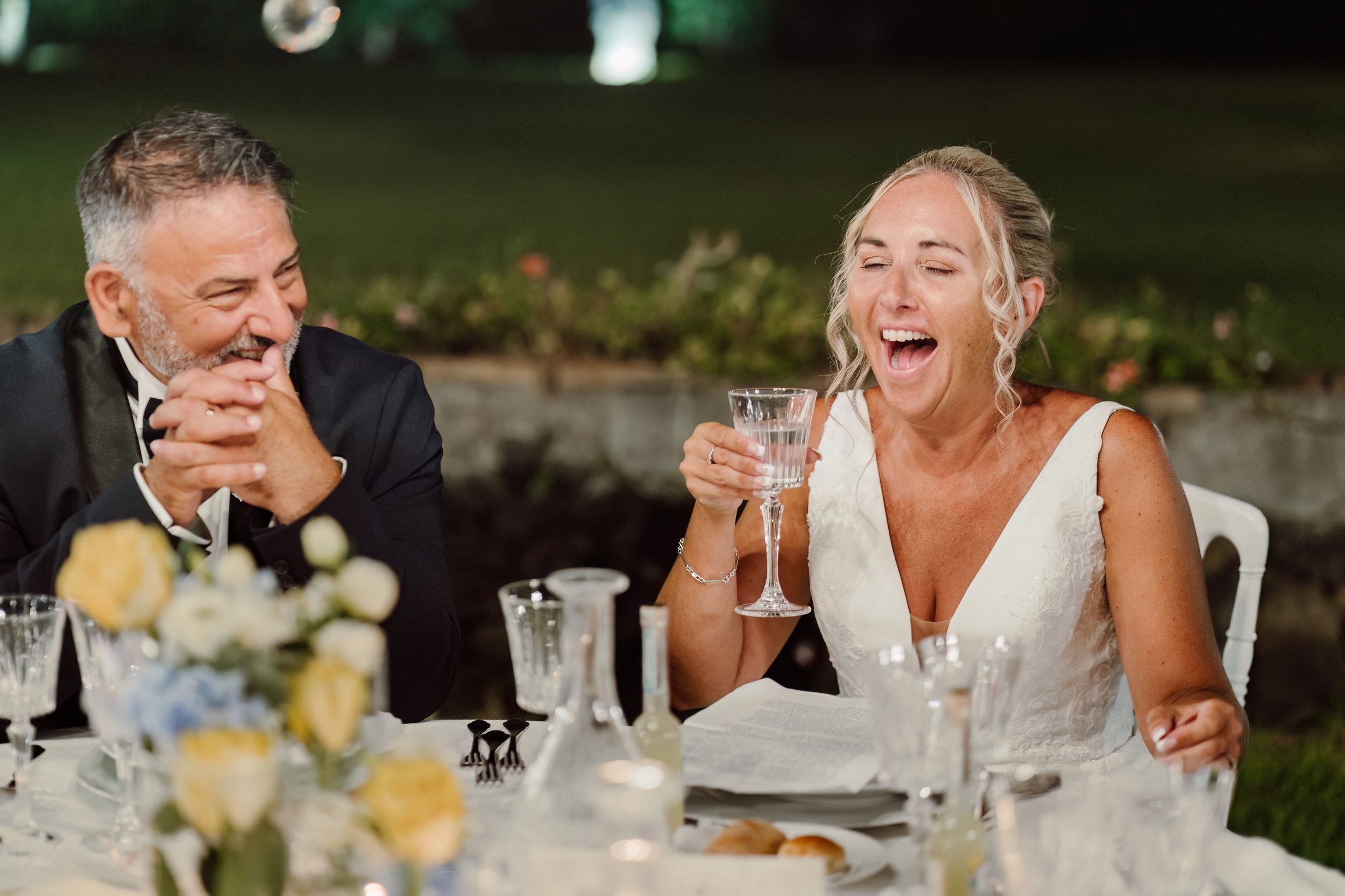 A toast at the dinner table, yellow roses on the cloth, Sicilian Wedding Day