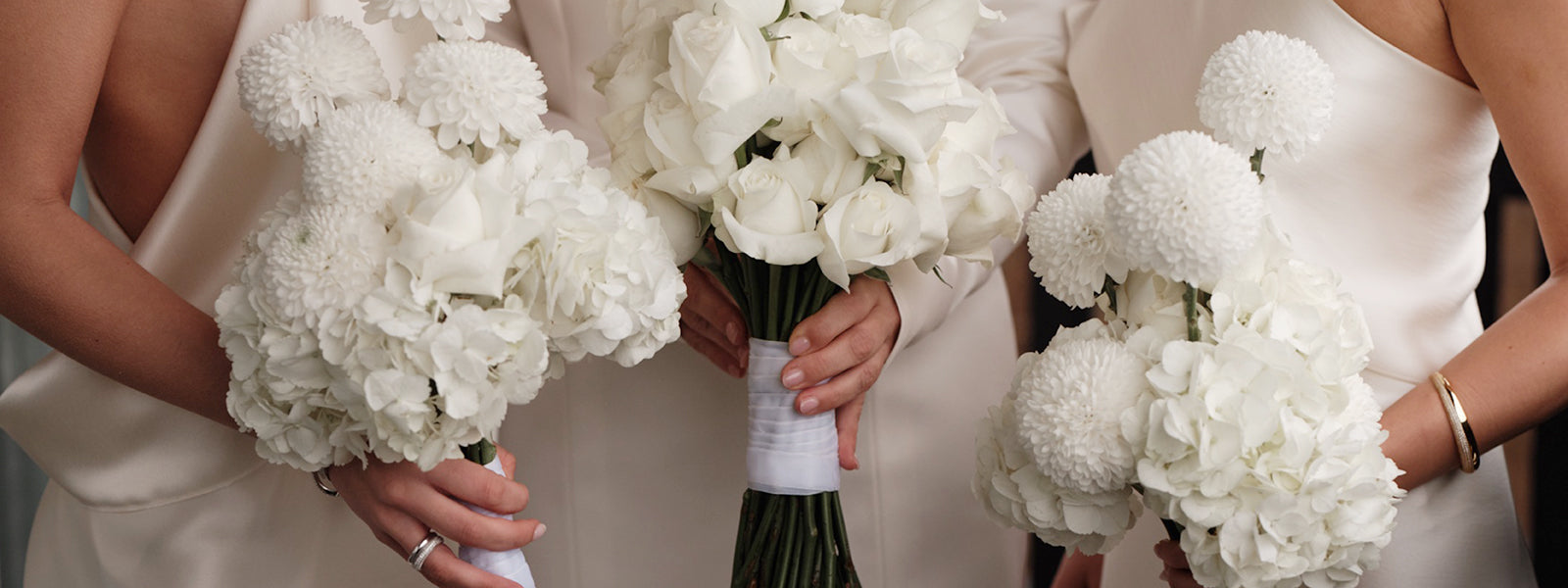 White bridal bouquets held by the bridal party, Sif Jakobs