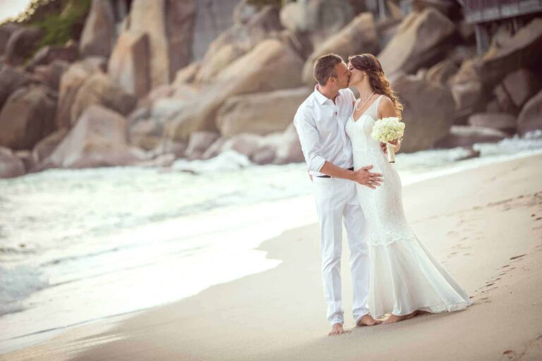 Couple on the beach among the granite boulders, Silavadee Pool Spa Resort