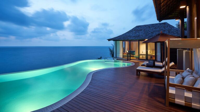 Pool villa terrace and curving infinity pool at dusk, Silavadee Pool Spa Resort