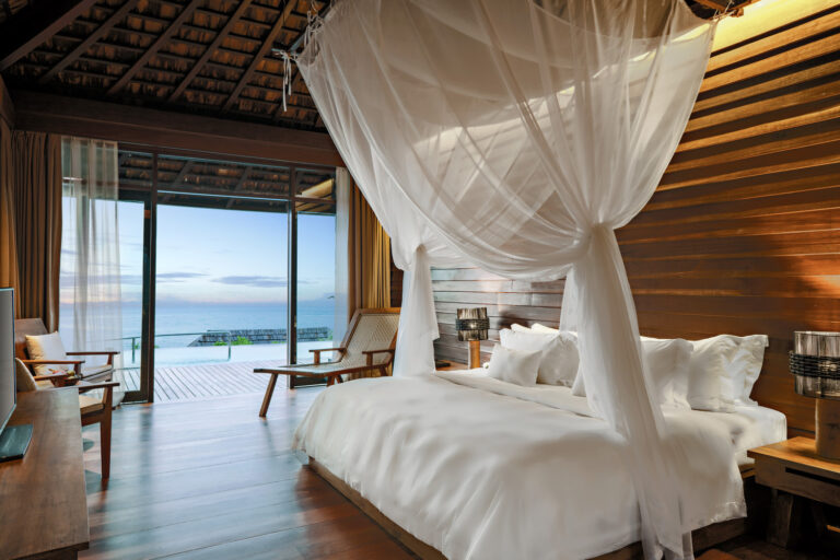 Scenic Ocean View Pool Villa bedroom with a canopied bed and sea view, Silavadee Pool Spa Resort