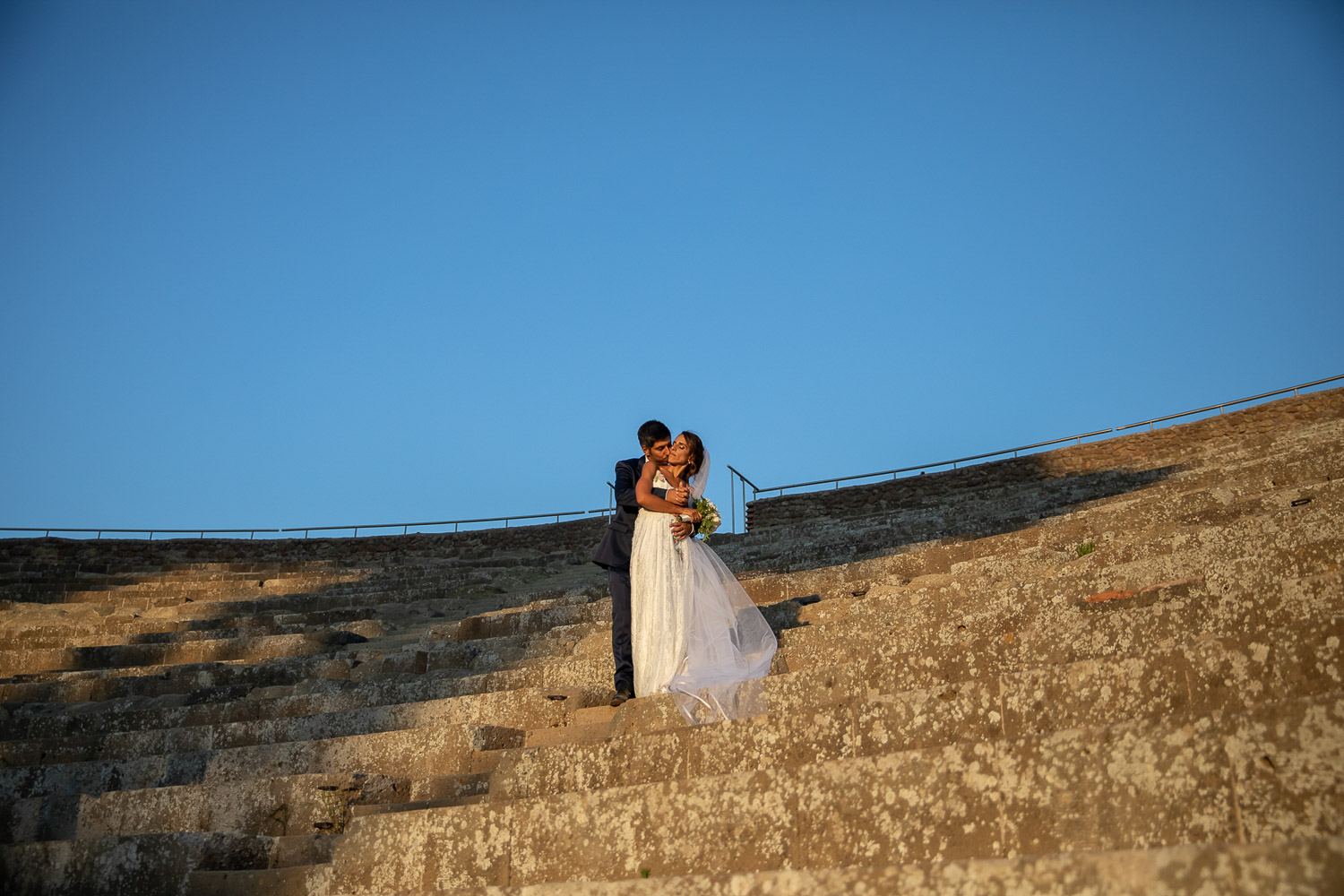 A kiss on the steps of the Roman theatre at Ostia Antica, before dinner at Scuderie Cicognani, Silvia Cleri Photography