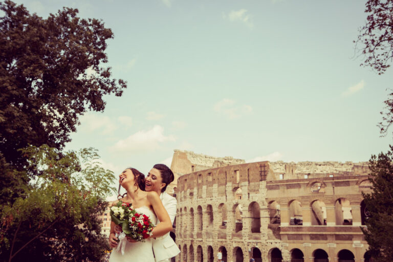 Two brides laughing in front of the Colosseum, Rome, Silvia Cleri Photography