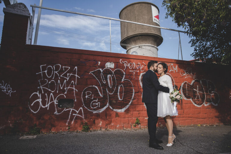 A winter wedding against a graffiti wall in the Ostiense district of Rome, Silvia Cleri Photography
