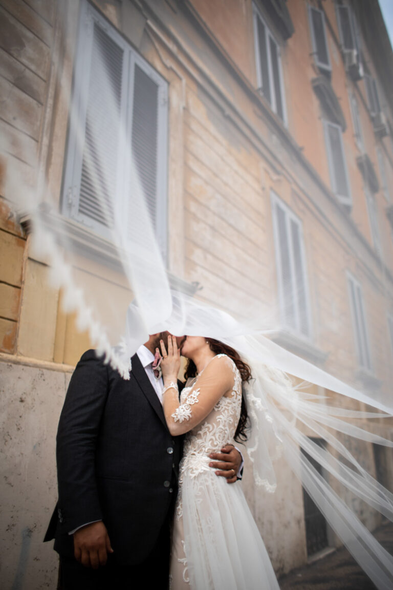 A kiss inside a wind-blown veil in the Prati district of Rome, Silvia Cleri Photography