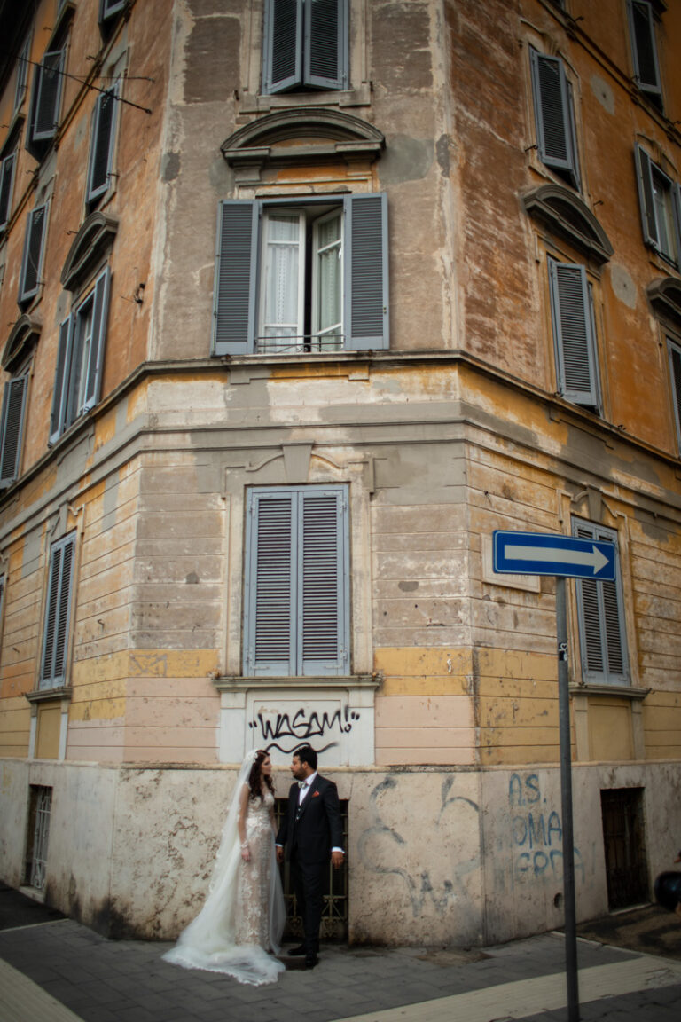 The couple on a street corner in Prati, Rome, where their story began, Silvia Cleri Photography