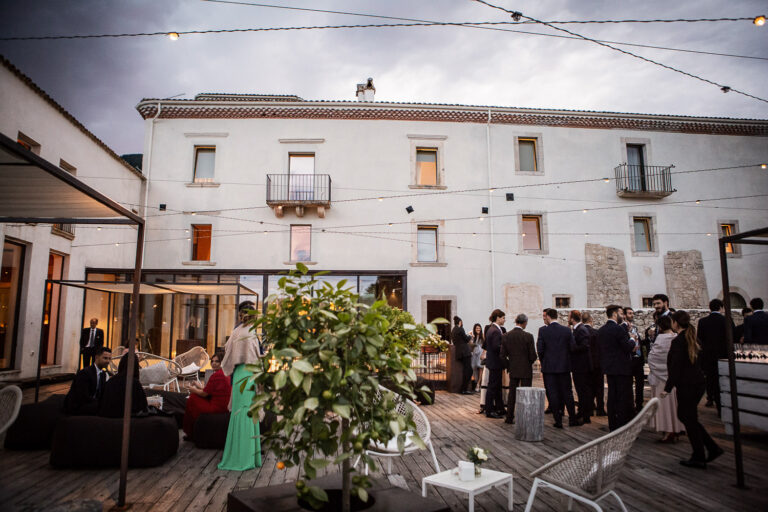Guests on the terrace at Reale Castel di Sangro, Abruzzo, as the lights come on, Silvia Cleri Photography
