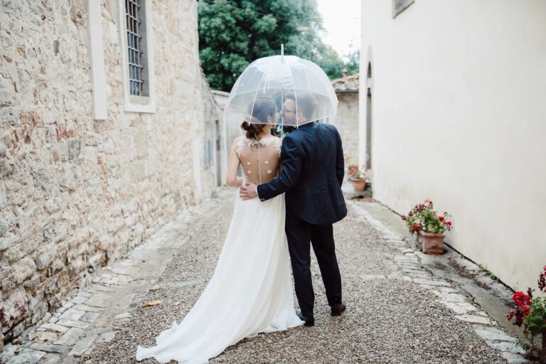 Under a clear umbrella in a stone village lane, Simone Perini Photography