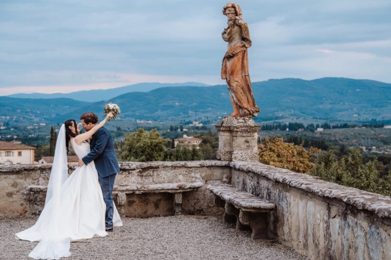 Chiara and Filippo on the statue terrace at Villa Corsini di Mezzomonte, the Tuscan hills behind them, Simone Perini Photography