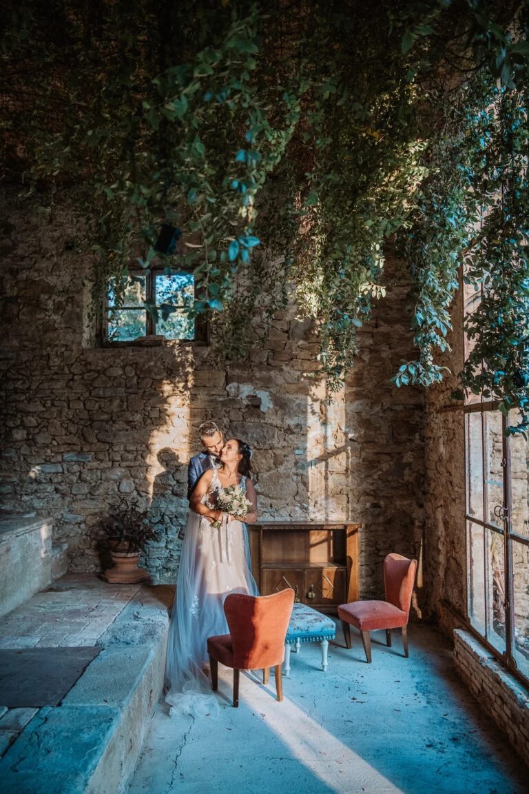 A quiet moment for the couple in a stone room hung with ivy, Simone Perini Photography