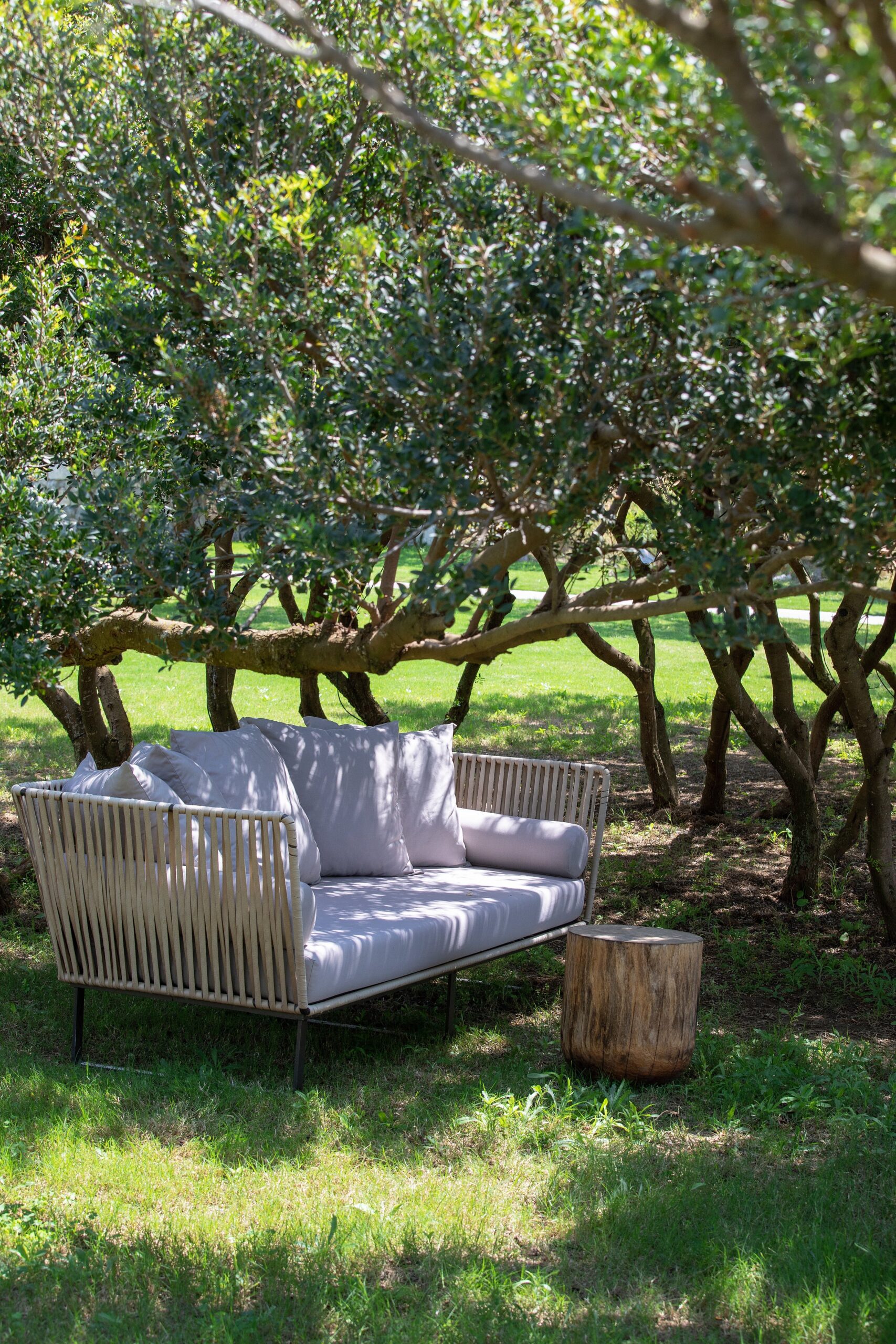 A garden sofa under trees on the resort grounds, Six Senses Kaplankaya
