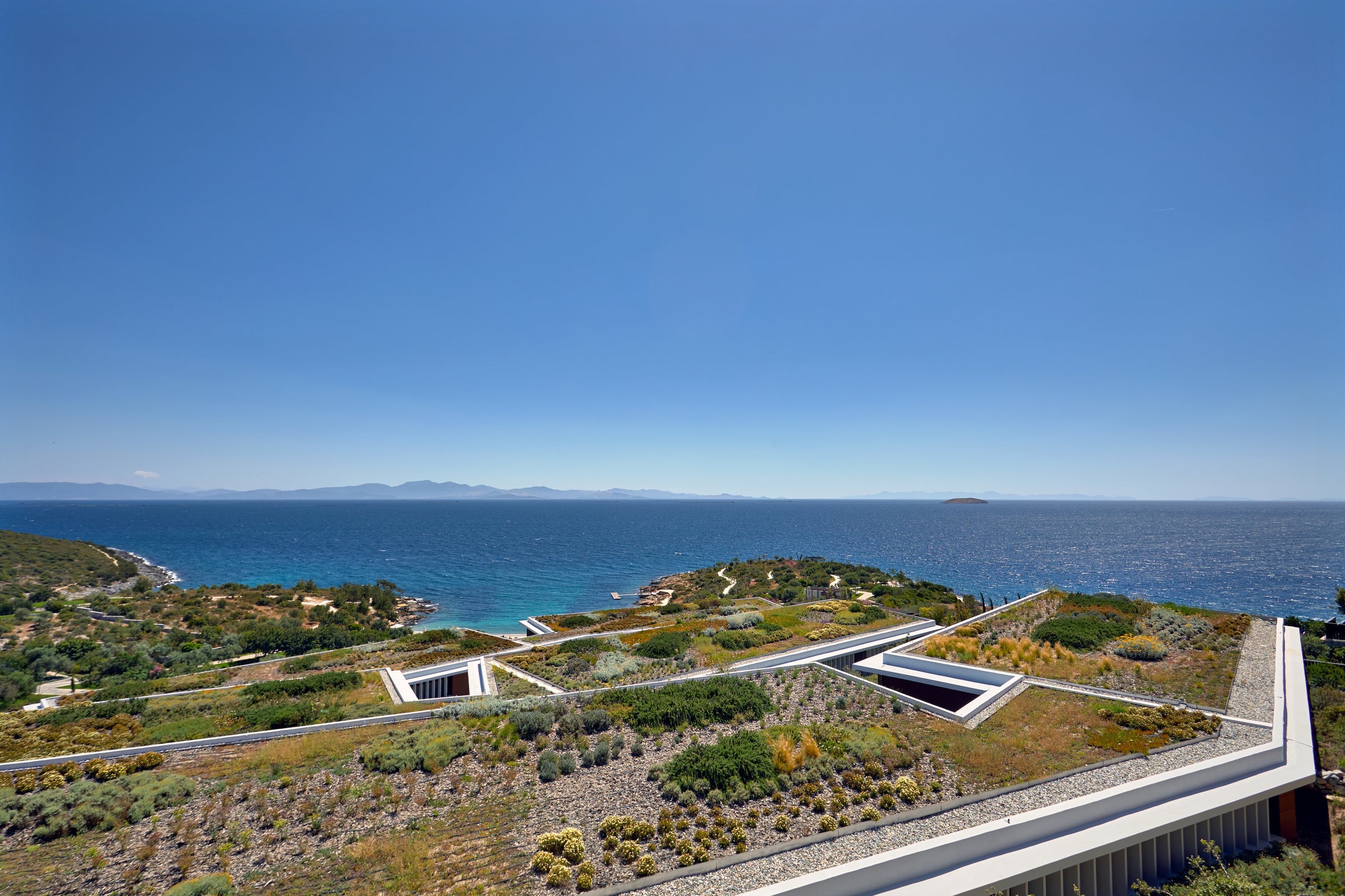 Green roofs of the resort buildings above the Aegean, Six Senses Kaplankaya