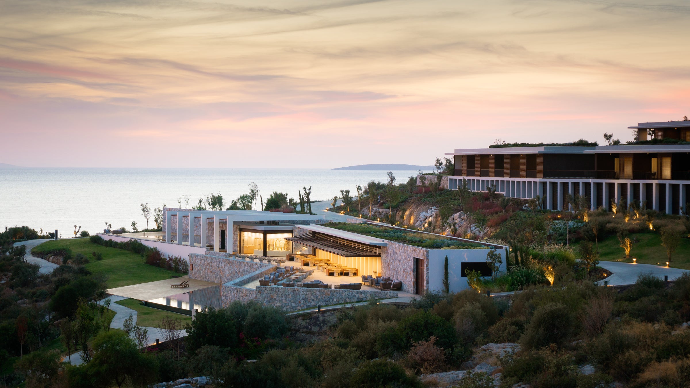 The resort buildings stepping down the hillside at sunset, Six Senses Kaplankaya