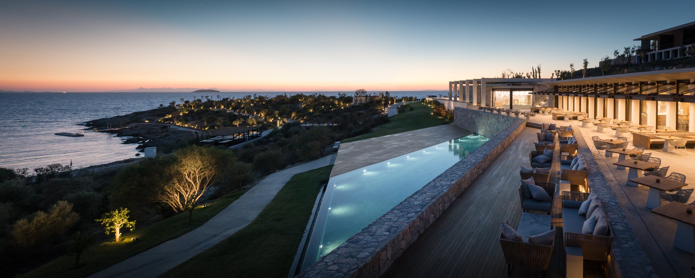 Infinity pool and terraces above the Aegean at dusk, Six Senses Kaplankaya