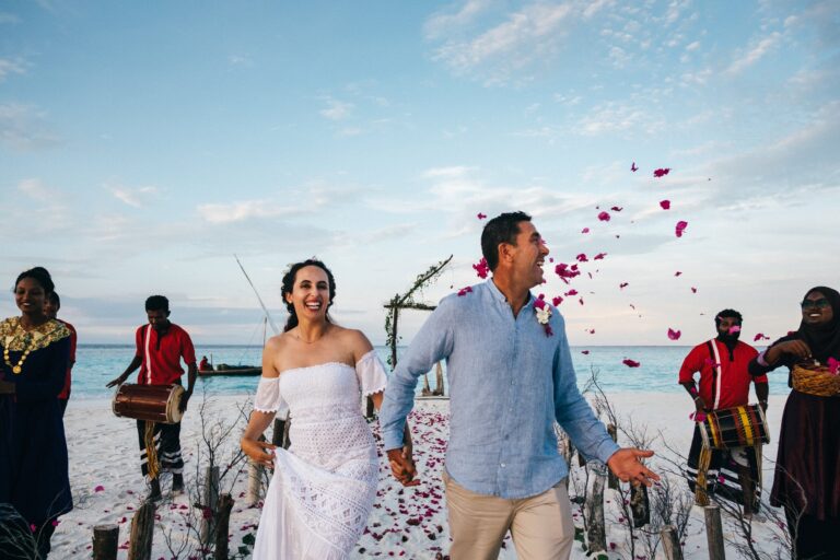 A couple married on the resort's private sandbank, with bodu beru drummers, Six Senses Laamu