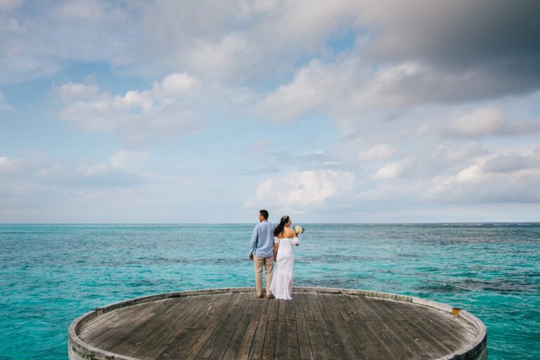 Newlyweds at the end of a jetty over the lagoon, Six Senses Laamu