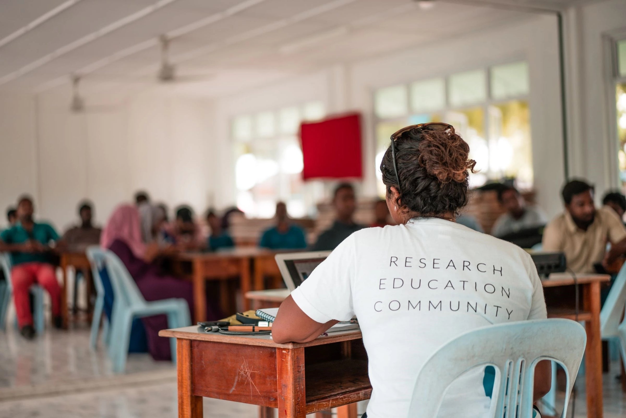 A community meeting in a classroom, Six Senses Laamu